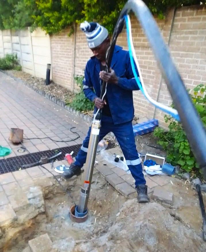 Chris Kenana installing a borehole pump